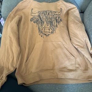 Brown sweatshirt with a cow on it.